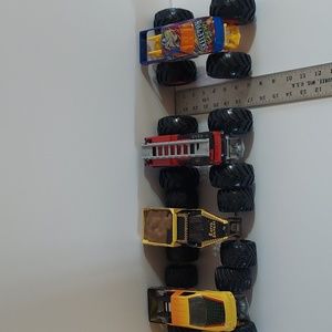 Four monter trucks by mattel these the large 1/24 scale